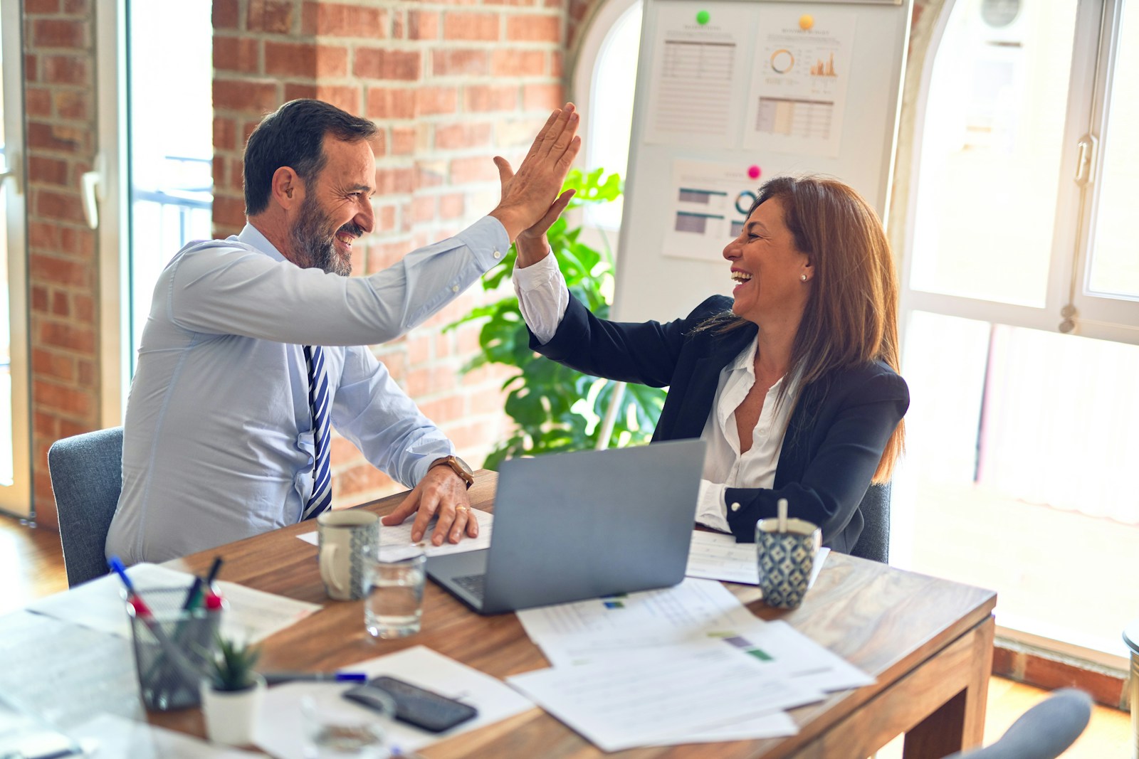 Two employees high-fiving